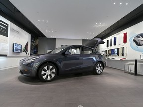 FILE - A Tesla Model Y Long Range is displayed on Feb. 24, 2021, at the Tesla Gallery in Troy, Mich. U.S. auto safety regulators have opened an investigation into Tesla's Model Y SUV after getting two complaints that the steering wheels can come off while being driven. The National Highway Traffic Safety Administration says the probe covers an estimated 120,000 vehicles from the 2023 model year.
