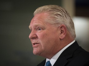 Ontario Premier Doug Ford answers questions following a press conference at a Shoppers Drug Mart pharmacy in Toronto, Wednesday, Jan. 11, 2023.&ampnbsp;Ford says voters in Toronto's upcoming mayoral byelection should not support anyone who wants to defund the police.