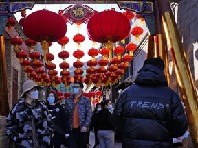 FILE - Shoppers visit a popular retail street in Beijing on Saturday, Feb. 26, 2022. Developing economies in Asia have mostly regained ground lost during the pandemic but are seeing their recoveries stall as productivity lags, the World Bank said in a report released Friday, March 31, 2023.