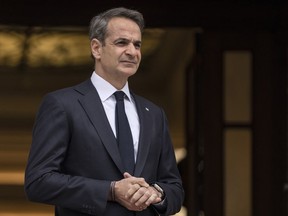 FILE - Greek Prime Ministers Kyriakos Mitsotakis looks on as he waits for the arrival of Cyprus' new President Nikos Christodoulides before their meeting in Athens, on March 13, 2023. Prime Minister Mitsotakis late Tuesday, March 22, said he would hold elections in May ‒ a month later than initially expected ‒ but did not give an exact date.