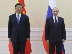 Chinese President Xi Jinping (left) and Russian President Vladimir Putin plan to meet Monday.