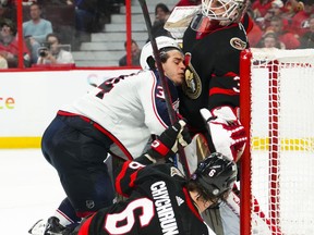 Columbus Blue Jackets centre Cole Sillinger (34) runs into Ottawa Senators goaltender Cam Talbot (33) during third period NHL hockey action in Ottawa on Saturday, March 4, 2023. Talbot will miss three crucial weeks as his team pushes for a playoff spot. The 35-year-old suffered a lower-body injury in Saturday's 5-2 home victory over the Blue Jackets.