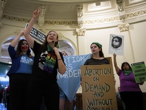FILE - Sarah Bentley, second from left, leads songs at an International Women's Day Sit-In for Abortion Rights in the Texas state Capitol Rotunda, Wednesday, March 8, 2023, in Austin, Texas. A federal judge in Texas overseeing a high-stakes case that could threaten access to medication abortion told lawyers not to publicize upcoming arguments in the lawsuit and that "less advertisement of this hearing is better," according to a transcript of the meeting released Tuesday, March 14.