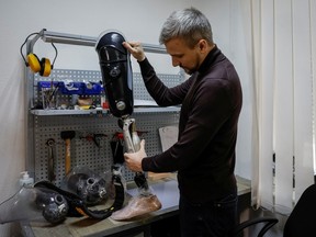 Andrii Ovcharenko, the head of the prosthetics clinic 'Without limits' shows a prosthetics, made in the clinic in Kyiv, Ukraine, March 9, 2023.