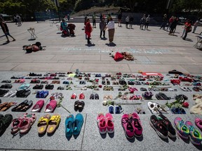 Two hundred and fifteen pairs of children's shoes are placed on the steps of the Vancouver Art Gallery n Vancouver on Friday, May 28, 2021, as a memorial to children who did not return from residential schools.
