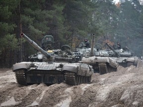 FILE - Ukrainian soldiers on captured Russian tanks T-72 hold military training close to the Ukraine-Belarus border near Chernihiv, Ukraine, Friday, Oct. 28, 2022.