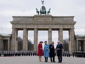 German President Frank-Walter Steinmeier, right, and his wife Elke Buedenbender, left, welcome Britain's King Charles III and Camilla, the Queen Consort, in front of the Brandenburg Gate in Berlin, Wednesday, March 29, 2023. King Charles III arrived Wednesday for a three-day official visit to Germany.