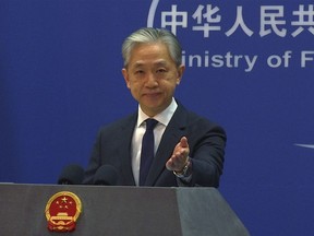 In this image made from video, Chinese Foreign Ministry spokesperson Wang Wenbin gestures during a media briefing at the Ministry of Foreign Affairs office in Beijing, Tuesday, March 14, 2023. The United States, Australia and the United Kingdom are traveling "further down the wrong and dangerous path for their own geopolitical self-interest," China's Foreign Ministry said Tuesday, responding to an agreement under which Australia will purchase nuclear-powered attack submarines from the U.S. to modernize its fleet.