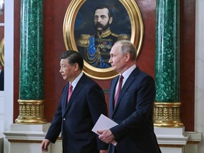 Russian President Vladimir Putin, right, and Chinese President Xi Jinping arrive to attend a signing ceremony following their talks at The Grand Kremlin Palace, in Moscow, Russia, Tuesday, March 21, 2023.