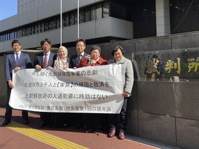 Two of five plaintiffs, Eiko Kawasaki, far right, and Hiroko Saito, second from right, their lawyers and supporters stand outside of the Tokyo High Court Friday, March 3, 2023, in Tokyo, after their first hearing in the appeals trial demanding North Korea pay damages over the 1959-1984 repatriation program which they say was illegal solicitation and detainment.