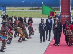 U.S. Vice President Kamala Harris, second right, is greeted by traditional dancers after landing in Lusaka, Zambia, Friday March 31, 2023. Harris is on the last leg of a a seven-day African visit that took her to Ghana and Tanzania.