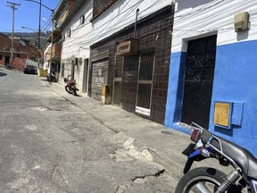 The second house from right to left, with a "No Parking" sign in Spanish on the door of its garage is the listed address of one of the startups involved in a massive corruption scandal that bilked billions of dollars in Venezuelan oil, and whose owner has never heard of the firm, at a working-class district in Caracas, Venezuela, Tuesday, March 28, 2023. The corporation, Walker International DW-LLC, is among 90 mostly unknown trading companies that together owed $10.1 billion as of Aug. 2022 to Venezuela's state-owned oil giant Petroleos de Venezuela SA, according to internal records obtained by The Associated Press.