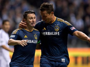 Los Angeles Galaxy's Robbie Keane, left, of Ireland, and Rob Friend celebrate Keane's goal against the Vancouver Whitecaps during second half MLS soccer action in Vancouver, B.C., on Saturday April 19, 2014. Friend is now in charge of the expansion Vancouver FC in the Canadian Premier League.