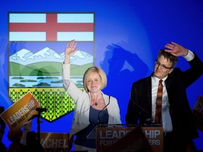 NDP leader Rachel Notley, left, and her husband Lou Arab react on stage after&ampnbsp;Notley was elected Alberta Premier in Edmonton on Tuesday, May 5, 2015.