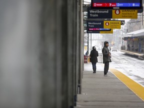 Two passengers wait for a transit train in Calgary on Wednesday, March 18, 2020. Calgary has announced an immediate action plan to make its city transit system safer amid growing security concerns.