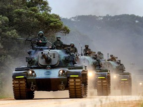Soldiers of Taiwanese Army take part in a military exercise at an undisclosed location in Taiwan in this handout picture provided by Taiwan Defence Ministry and released on April 9, 2023.