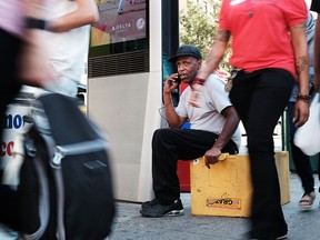 A man uses one of the new Wi-Fi kiosks that offer free web surfing, phone calls and a charging station on August 24, 2016 in New York City.