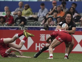 New Zealand's Portia Woodman-Wickliffe tries to break away from Canada's Shalaya Valenzuela during the second day of the Hong Kong Sevens rugby tournament in Hong Kong, Saturday, April 1, 2023.
