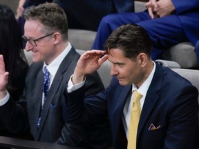 Michael Kovrig, right, and Michael Spavor react as they listen to an address from U.S. President Joe Biden in the House of Commons in Ottawa on March 24.