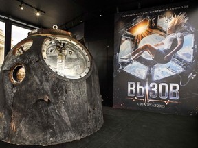 The Soyuz capsule which brought Klim Shipenko and Yulia Peresild back to Earth is on display in Moscow next to a poster for The Challenge.