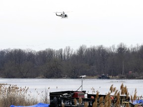 A police helicopter conducts a search after a number of bodies were found in the area around Akwesasne, Quebec, March 31, 2023.