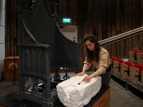 A curator cleans a 3D model of the Stone of Destiny during a press event at The Engine Shed in Stirling, Scotland.