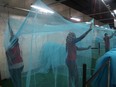 Workers look for holes in mosquito netting at the A to Z Textile Mills factory producing insecticide-treated bednets in Arusha, Tanzania, in a file photo from 2016.