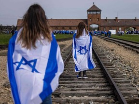 Participants in the annual March of The Living walk along the train tracks to the Birkenau camp, part of the former Auschwitz-Birkenau concentration camp at the village of Brzezinka near Oswiecim, Poland, on April 18, 2023.