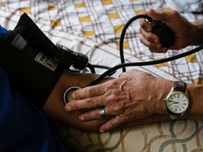 A person has their blood pressure checked.