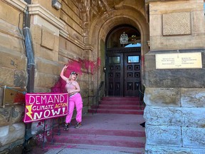 A climate activist from On2Ottawa threw a bucket of pink paint on the entrance to the Prime Minister's Office in Ottawa before chaining herself topless to the office door on April 18, 2023.