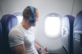man with headphones on plane