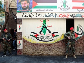 Members of the Popular Front for the Liberation of Palestine stand guard during an Al-Quds Day parade in Beirut on April 14.