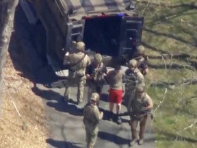 FBI agents arrest U.S. Air Force National Guardsman Jack Teixeira,  in connection with online leaks of classified U.S. documents, outside a residence in this image taken from video in North Dighton, Massachusetts, April 13, 2023.
