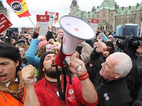 PSAC President Chris Aylward, right, and Alex Silas picket on Parliament Hill on April 26, 2023. Columnist Sabrina Maddeaux says the union's demand that any future layoffs be based on seniority would disadvantage young workers and stifle innovation in the public service.