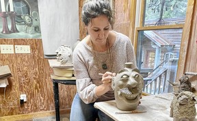 Crystal King works on a face jug at her gallery in Seagrove, N.C., a mecca for potters.