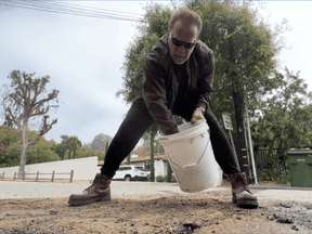 Arnold Schwarzenegger fixing a pothole, April 11, 2023.