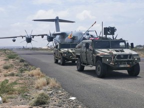 Spanish military plane and military vehicles are seen departing on tarmac as Spanish diplomatic personnel and citizens are evacuated, in Khartoum, Sudan. Canada is prepared to get citizens out of the country, with two vessels waiting off the coast.