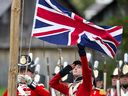 Re-enactment participants dressed as early 19th-century British soldiers lower the Union Jack in a file photo from Fanshawe Pioneer Village in London, Ont. A controversial new book by Nigel Biggar asks readers to consider both the good and bad aspects of the British Empire’s legacy.