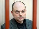 Russian opposition activist Vladimir Kara-Murza sits on a bench inside a defendants' cage during a hearing at the Basmanny court in Moscow in a file photo from Oct. 10, 2022. A Russian prosecutor has requested 25 years of imprisonment for the Kremlin critic.