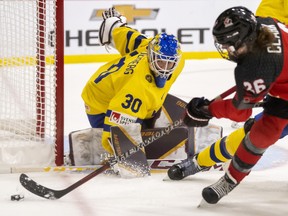 Sweden goaltender Emma Soderberg makes a save on Canadian forward Emily Clark during IIHF Women's World Hockey Championship quarterfinal action in Brampton, Ont., April 13, 2023.