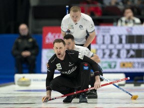 Scotland lead Hammy McMilllan and second Bobby Lammie look over the shoulder of Canada skip Brad Gushue as he calls to teammates and his shot enters the house in the fifth end during action in the finals at the Men's World Curling Championship in Ottawa on Sunday, April 9, 2023.