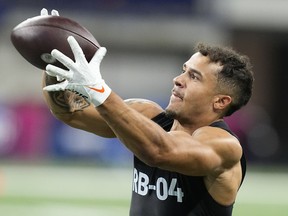 Illinois running back Chase Brown runs a drill at the NFL football scouting combine in Indianapolis, Sunday, March 5, 2023. Five Canadians are projected to be selected in this year's draft, which begins Thursday night in Kansas City.&ampnbsp;