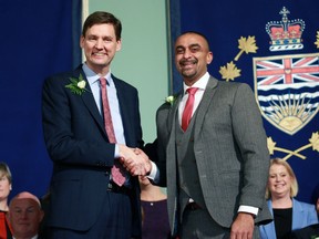 Premier David Eby shakes hands with Housing Minister and government house leader Ravi Kahlon during a swearing-in ceremony at Government House in Victoria, Wednesday, Dec. 7, 2022. The British Columbia government has introduced a multibillion-dollar plan to construct more homes sooner in an attempt to build its way out of the housing crisis.