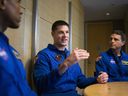 Canadian Space Agency astronaut Jeremy Hansen, centre, participates in interviews with fellow members of the Artemis II crew, NASA astronauts Victor Glover, left, Reid Wiseman, right.