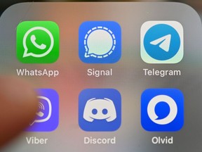 This picture taken on Januray 22, 2021 in Rennes, western France, shows a smartphone screen featuring messaging service applications WhatsApp, Signal, telegram, Viber, Discord and Olvid.