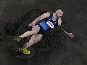 FILE - Izmir Smajlaj, of Albania, during a qualifications round in the men's long jump at the 2020 Summer Olympics in Tokyo, Saturday, July 31, 2021. Two top track and field officials in Albania have been banned for falsifying an athlete's result to help him qualify for the Tokyo Olympics. The Athletics Integrity Unit says long jumper Izmir Smajlaj was cleared of being part of the conspiracy to falsely register a national record in May 2021.