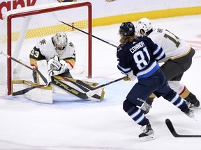 Vegas Golden Knights goaltender Adin Hill (33) makes a save on Winnipeg Jets' Kyle Connor (81) during third period NHL action in Winnipeg on Tuesday December 13, 2022.
