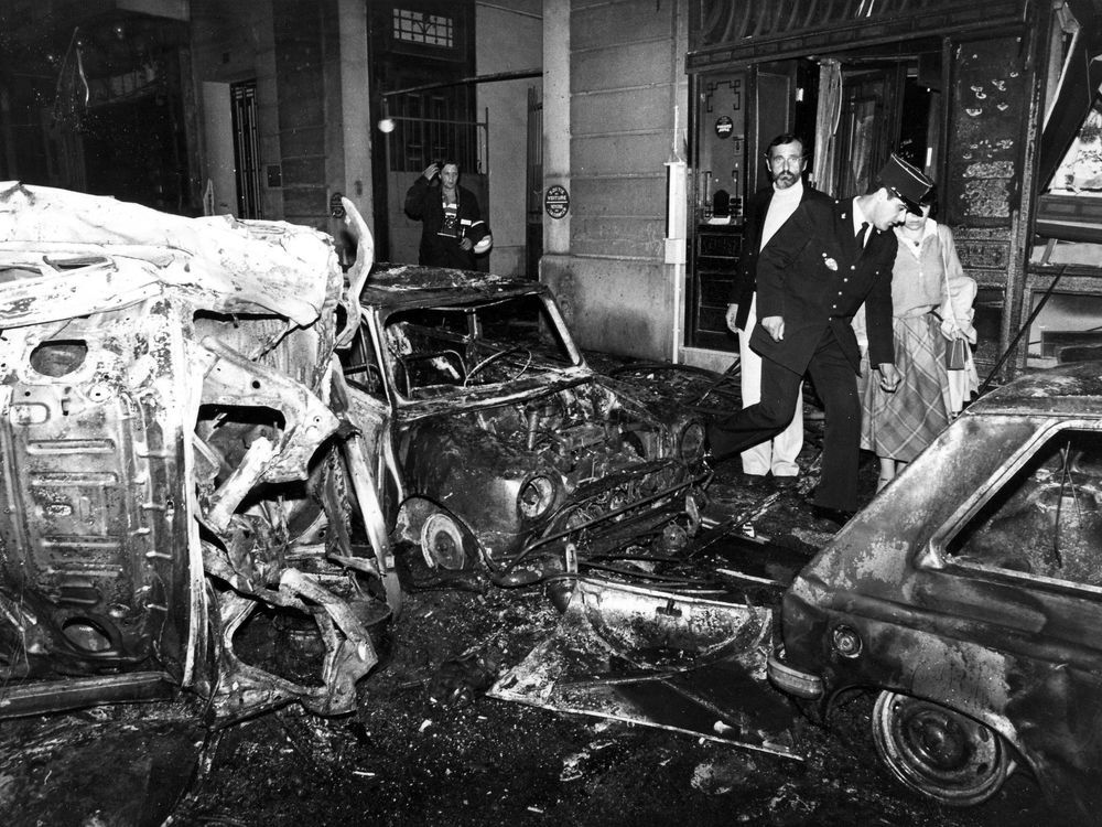 FILE – A police officer walks at the scene after the bombing of the Copernic street synagogue, in Paris, that killed 4 people on This Oct. 3, 1980. A Lebanese-Canadian academic and lone suspect in a 1980 bombing outside a Paris synagogue will go on trial Monday April 3, 2023, nearly 43 years after four people were killed and dozens wounded in the unclaimed attack.
