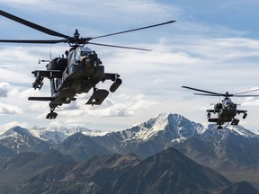 In this photo released by the U.S. Army, AH-64D Apache Longbow attack helicopters from the 1st Attack Battalion, 25th Aviation Regiment, fly over a mountain range near Fort Wainwright, Alaska, on June 3, 2019. The U.S. Army says two Army helicopters similar to the ones in this picture crashed Thursday, April 27, 2023, near Healy, Alaska, killing three soldiers and injuring a fourth. The helicopters were returning from a training flight to Fort Wainwright, based near Fairbanks.