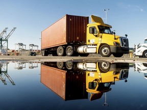 FILE - A truck departs from a Port of Oakland shipping terminal on Nov. 10, 2021, in Oakland, Calif. On Friday, April 28, 2023, California regulators voted to end the sale of new diesel-powered big rigs and buses in the state by 2036.